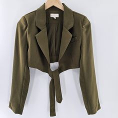 Torn By Ronny Kobo Cropped Olive Green Wrapped Button Back Zuna Blazer New With Tags Retails $398 Size Small This Is A Beautiful Oliver Green(Army Green) Wrapped Cropped Blazer. The Blazer Wraps Around With Button Closure On The Back. The Blazer Features Long Sleeves, With Shoulder Pads( Not Removable) And A Fold Over Notched Lapel. There Is Faux Pocket On The Left Chest. This Blazer Has A Very Lightweight Lining. *** As Seen On The Pictures ( Circled In White) . There Is Supposed To Be Two Butt Chic Khaki Cropped Jacket For Work, Trendy Fitted Cropped Jacket With Buttons, Fitted Outerwear With Button Closure For Day Out, Trendy Cropped Jacket With Buttons For Work, Fitted Khaki Button-up Blazer, Fitted Chic Khaki Blazer, The Politician, Sequin Blazer, Puffy Vest