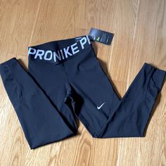 Black Nike Pro Tight Fit Training Dri Fit Mid Rise; Approx. Inseam: 27" Wide Elastic Waistband; Curved Seams At Back Body, Mesh: Polyester (50% Recycled)/Spandex Nike Fitted Running Leggings, Nike Fitted Yoga Pants, Nike Fitted Yoga Pants For Workout, Nike Fitted Yoga Pants For Athleisure, Nike Fitted Moisture-wicking Leggings, Nike Fitted Go-dry Leggings, Fitted Nike Leggings With Moisture-wicking, Fitted Nike Black Tights, Nike Black Fitted Tights