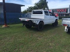 a white truck is parked in the grass