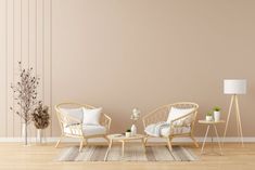 a living room with two wicker chairs and a coffee table in front of a beige wall