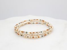 ◉ This listing is for a single bracelet, or a stack of 3. ◉ Bracelet Set Each bracelet is made with flexible elastic, making the set easy to wear individually or stacked for a layered, meaningful touch to your everyday style. ◉ Feature  - 2mm 14k Gold Filled Beads - 3mm 14k Gold Filled Beads - 4mm 14k Gold Filled Beads - 2mm Miyuki seed beads - Stretch Cord, pre-stretched to stay the same size ◉ Sizing Tips Please measure your wrist to find your best fit. 1. Gentry wrap a soft measuring tape or tape around your wrist. 2. Add 1/4" to the measurement for a snug fit or 1/2" to the measurement for a comfortable fit. ◉ Shipping Canada: - Free Standard Shipping via Canada Post. (No tracking) - Tracked Shipping available through Chit Chats. USA: All orders include tracked shipping through Chit Ch Gold Minimalist Stretch Bracelet With Tiny Beads, Minimalist Yellow Gold-plated Beaded Bracelets, Dainty 14k Gold-filled Stretch Bracelet With Gold Beads, Gold Stretch Bracelet With 14k Gold-filled Beads, Elegant 14k Gold-filled 8mm Beaded Bracelets, Single Bracelet, Bracelet Dainty, Dainty Bracelet, Measuring Tape