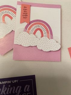 two greeting cards with pink and white designs on them, one has a rainbow in the middle