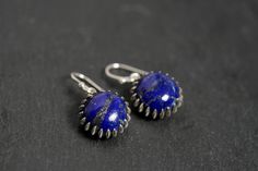 Lapis Lazuli stone is beautiful, textured deep blue with hits of gold color in it, stunning! Such a pretty, modern silver bezel. Earrings are 10mm 13mm with the sterling bezel. Sterling Silver Ear Hooks. -PRESENTATION & GIFTING- All of our jewelry comes beautifully wrapped in a hand stamped kraft jewelry box with a bow; ready for gifting! Just leave a note and I will include a personalized message for your gift recipient. Every piece of jewelry comes with a free cleaning cloth! -ABOUT US- We've Blue Minimalist Pierced Jewelry, Unique Blue Earrings For Everyday, Unique Blue Everyday Earrings, Everyday Blue Earrings With Natural Stones, Handmade Round Lapis Lazuli Earrings, Minimalist Blue Earrings For Formal Occasions, Elegant Sapphire Earrings Adjustable, Everyday Blue Jewelry With Matching Earrings, Blue Lapis Lazuli Earrings For Formal Occasions