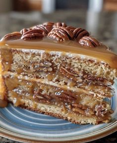 a piece of cake on a plate with pecans and caramel drizzle