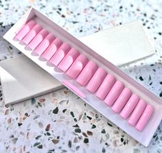 "baby pink medium square press-on nails in shade \"Babydoll\". The set includes various accessories such as a nail file, cuticle pusher, buffer, nail glue, stick tabs, and 18-20 nails. Additionally, the set also comes with a free jewelry piece and free cuticle oil. These press-on nails can last for 3-4 weeks if properly cared for and can be reused. It is worth noting that all the press-on nail sets include extra sizes to ensure a good fit, even if the buyer is unsure of their size." Nails Barbie, Barbie Pink Nails, Square Press On Nails, Baby Pink Nails, City Nails, G Nails, Young Nails, Nail Sets, Glue Stick