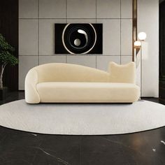 a white couch sitting on top of a black floor