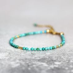 This handmade, genuine Turquoise Bracelet for women is dainty yet striking, bringing a colourful, boho touch to any outfit. Stylish and minimal worn alone, but great to mix, match & stack. A very dainty, skinny bracelet with a delicate, feminine, minimal look - made with 2.25mm tiny turquoise beads. Featuring genuine, natural, un-dyed Turquoise in a variety of green, turquoise and teal shades - all the beautiful shades of the tropical seas! Excellent cut with many facets, showing off the gor Spiritual Turquoise Beaded Bracelets With Tiny Beads, Adjustable Hand-strung Turquoise Bracelets, Spiritual Turquoise Beaded Bracelet With Tiny Beads, Spiritual Turquoise Bracelets With Tiny Beads, Spiritual Turquoise Beaded Bracelet, Adjustable Turquoise Stretch Bracelet With Tiny Beads, Handmade Adjustable Turquoise Stretch Bracelet, Hand-strung Turquoise Friendship Bracelets, Hand-strung Turquoise Bracelets For Friendship