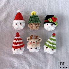 small crocheted gnomes are arranged on a white sheet