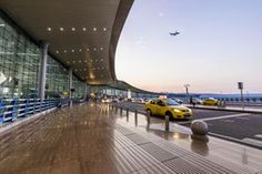 an airport with cars parked in front of it