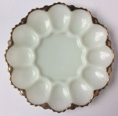 a white plate with gold trim around it