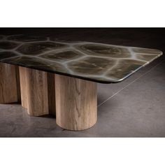 the table is made out of wood and has an unusual design on it's surface