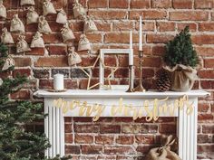 a fireplace with christmas decorations on it next to a tree and other holiday decor items