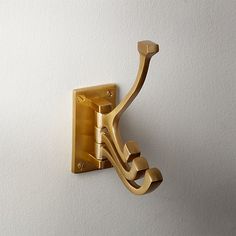 a gold metal hook on the wall