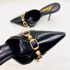 New With Box Brand: Liliana Color: Black, Gold Embellishment Tts Runs True To Size These Gorgeous Pointy Toe Mules Heel Is Must Have! They Are Super Comfortable To Put On And Off. You Can Just Slide In And Go On With Your Busy Schedule. They Are Made With Faux Vegan Leather, Padded Insole For Extra Comfort, Chic Closed Pointy Toe And Finished With Biker Chic Stud And Buckle Strap Detail. This Slip On Mules Will Go Perfect With Balenciaga City Bags! Moto Modern Luxe Classic -Easy Slip On -Closed Black Open Toe Heels With Metal Pin Buckle, Trendy High Heel Mules For Party, Trendy Pointed Toe Party Mules, Black High Heels With Metal Pin Buckle, Black Pointed Toe Mules With Buckle Closure, Trendy High Heel Mules With Buckle Closure, Open Toe Heels With Metal Pin Buckle For Party, Black Heels With Metal Pin Buckle For Spring, Party Heels With Ankle Strap And Metal Pin Buckle