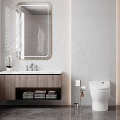 a white toilet sitting next to a sink in a bathroom under a mirror and towel rack