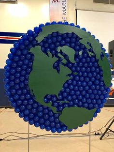 a blue and green globe on display in a building