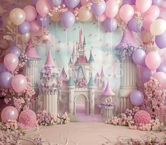 a backdrop with balloons, flowers and castle in the background for a princess themed birthday party