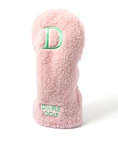 a pink stuffed animal with the letter d on it's head and green lettering