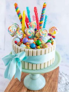 a cake decorated with candy and lollipops