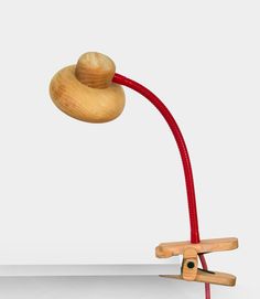 a wooden object with a red cord attached to it's end and a light on top