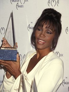 the singer poses with her award for outstanding performance in a musical play