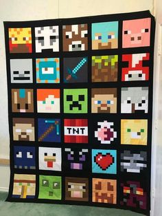 a quilt made to look like the video game characters are on display in a room