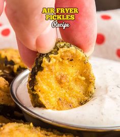 a person dipping something into a bowl with ranch dressing on it and the words air - fryer pickles recipe below