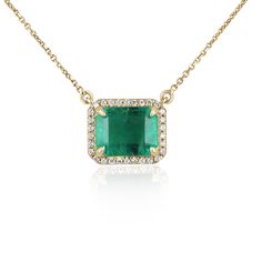 Featured here is a stunning statement size East to West rich bluish green emerald and round diamond halo necklace handmade in fine 14K yellow gold. Displayed is a lustrous, medium-rich green with very good transparency, accented by a simple secure four-prong 14K mount, allowing for the gorgeous large emerald to be shown in full view. Brilliant round natural diamonds halo sparkle around the emerald. The chain is stationary and is an adjustable 18-16 inch long necklace to easily wear in different Fine Jewelry Green Diamond Gemstone Necklace, Green Gemstone Diamond Necklace In Fine Jewelry Style, Formal Emerald Gemstones With Accents, Formal Gia Certified Emerald Necklace, Gia Certified Green Necklace For Formal Occasions, Formal Green Gia Certified Necklace, Fine Emerald Diamond Necklace, Emerald Diamond Necklace In Fine Jewelry Style, Emerald Cut Green Diamond Gemstone Necklace