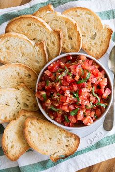 a bowl of salsa with bread on the side