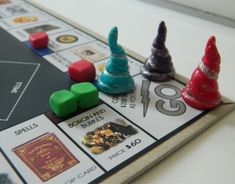 a monopoly board game with colorful dices and christmas trees on the top, sitting on a table