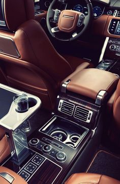 the interior of a luxury car with brown leather seats and center console, steering wheel controls and dash board