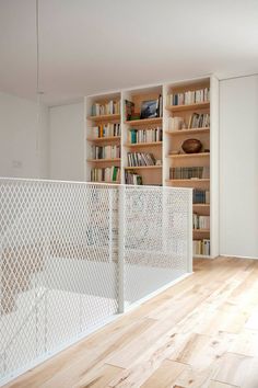 an empty room with bookshelves and wooden floors