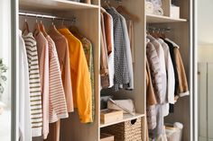 an organized closet with clothes and baskets