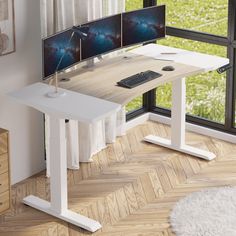 a computer desk with two monitors and a keyboard on it in front of a window