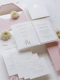 pink and white wedding stationery with gold monogrammed initials on the front, inside and out