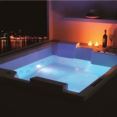 a hot tub with candles lit up in the background