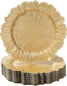 a gold plate with black and white stripes on the edge, next to a stack of plates