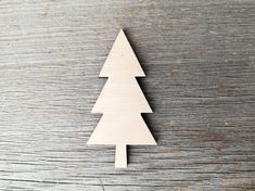 a wooden christmas tree sitting on top of a table