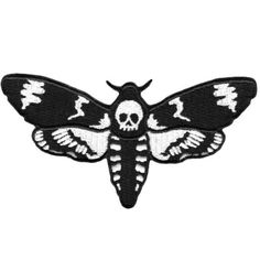 a black and white moth with skulls on it's wings, in the shape of a