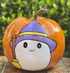 a painted pumpkin with a scarecrow on it