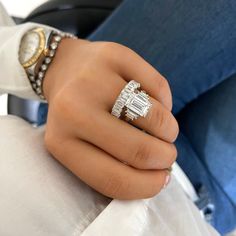 a close up of a person's hand holding a ring