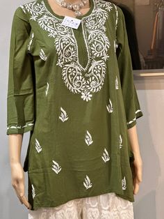 *mehndi green kurti  *Ethnic motifs plain  *round neck  ,short,regular sleeves  *Embroidery work on  neck  *Machine weave regular Cambric cotton  Bust:19.5 Waist:18 Hip:21 Length:30 Bohemian Green Straight Kurta Tunic, Green Bohemian Straight Kurta Tunic, Green Long Sleeve Traditional Wear With Motifs, Traditional Green Kurta With Self Design, Green Chikankari Embroidered Tunic For Summer, Bohemian Green Kurta With Chikankari Embroidery, Green Bohemian Kurta With Chikankari Embroidery, Bohemian Pista Green Kurta With Chikankari Embroidery, Green Tops With Motifs For Festivals