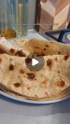 two flat breads sitting on top of a white plate