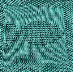 a green knitted blanket with squares on the top and bottom, in shades of teal