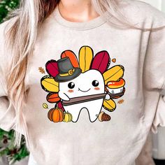 Dental Thanksgiving Shirt, Fall Dental Shirt, Thankful Dental Shirt, Funny Turkey Shirt, Dental Hygienist Shirt, Dental Assistant Shirt ♥ All items are made to order. ♥ Production & shipping time:  - Production time is 3 - 5 business days from order date - Shipping time:  + Standard shipping: 5 - 7 business days + Express shipping: 3 - 5 business days ♥ Shirt Sizing: Unisex fit and run true to size. If you are unsure on sizing, please use our sizing chart in the product image for reference. ♥ Care Instructions: Wash with cold water, inside out. ♥ Returns & Exchanges I do not offer exchanges, returns, or refunds. ♥ Custom Orders I love custom orders!  If you don't see something in my shop please message me and I will do my best to make it happen for you!! Dental Thanksgiving, Dental Shirt, Dental Assistant Shirts, Dental Shirts, Funny Turkey, Turkey Shirts, Dental Humor, Thanksgiving Shirt, Dental Hygienist