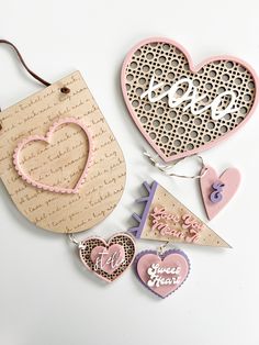 some cut out hearts and tags on a white surface