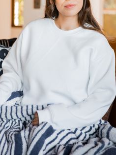 Made with the softest materials, this sweatshirt is designed to keep you warm and comfortable all season long. Whether you are lounging at home or running errands, this sweatshirt will be your go-to choice. Sizing: Small 4-6 Medium 8-10 Large 12-14 XL 14-16 Soft Long Sleeve Sweatshirt For Loungewear, Oversized Athleisure Sweatshirt For Relaxation, Solid Color Fleece Sweats For Everyday, Fleece Sweats For Everyday, Comfy Relaxed Fit Sweatshirt For Relaxation, Crew Neck Sweatshirt With Ribbed Cuffs For Relaxation, Relaxation Crew Neck Sweatshirt With Ribbed Cuffs, Oversized Crew Neck Sweatshirt For Relaxation, Super Soft Long Sleeve Sweatshirt For Winter