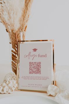 a coffee fund card sitting on top of a white plate next to some dried flowers