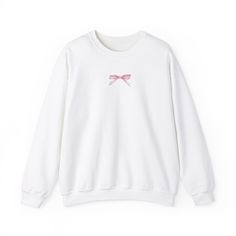 Introducing our latest crew neck sweatshirt ; a perfect blend of comfort and style. Embrace the charm of a cute aesthetic with a delicate pink ribbon, beautifully adorning this cozy piece. Beyond the ordinary, this sweatshirt captures the essence of femininity in a unique way, blending comfort with a touch of elegance. Elevate your wardrobe with this pink-themed delight, making a statement that goes beyond fashion; it's a symbol of grace and individuality. Ideal for any situation, a unisex heavy Feminine Crew Neck Winter Sweater, Feminine Crew Neck Sweater For Winter, Cute Pink Sweatshirt With Ribbed Cuffs, Cute Crew Neck Sweatshirt With Ribbed Cuffs, Feminine Cotton Winter Sweater, Feminine Cotton Sweater For Winter, Feminine White Crew Neck Sweater, Grace Symbol, Jan 1