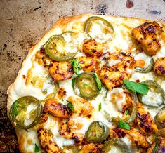 a pizza topped with chicken, peppers and cheese